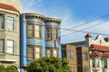 Row of decorative colorful houses with visible powerlines and modern home facades in San Francisco California Royalty Free Stock Photo