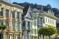 Row of decorative houses in historic districts of San Francisco California with colorful facades and sun streaked front Royalty Free Stock Photo