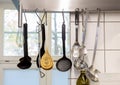 Row of decorative spats suspended from the ceiling in a kitchen setting. Royalty Free Stock Photo