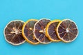 Row of dehydrated citrus fruits lemons on blue background Royalty Free Stock Photo