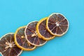 Row of dehydrated citrus fruits lemons on blue background. Slices Royalty Free Stock Photo