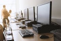 Row of desktop computers in classroom