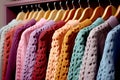 Row of different colorful Knitted warm sweaters hang, Rack with stylish women\'s clothes autumn colored. Clothes for Royalty Free Stock Photo