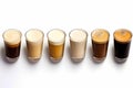 Row of different types of drinks in glasses on white surface. Generative AI Royalty Free Stock Photo