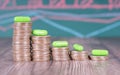 A row of diminishing dollar coins and a row of capsule drugs on top of them Royalty Free Stock Photo