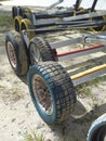 Row of Dinghy Sailing Wagon Wheels on Sand. Boat trailers. Beach carts background Royalty Free Stock Photo