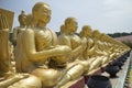 Row of disciple statues surrounding Big buddha statue Royalty Free Stock Photo