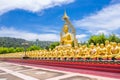 Row of disciple statues surrounding big buddha statue in public to the general public worship worship, Thailand