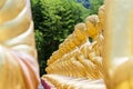 Row of disciple statues surrounding big buddha statue in public to the general public worship worship Royalty Free Stock Photo