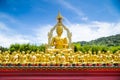 Row of disciple statues surrounding big buddha statue