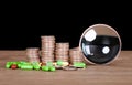 A row of dollar coins, a magnifying glass and capsule medicines scattered on the table in front of a dark background Royalty Free Stock Photo