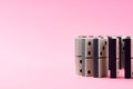 Row of domino tiles on pink studio background close up Royalty Free Stock Photo