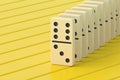 Row of domino tiles on yellow boards