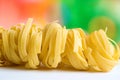 Row dry nest pasta on colored background