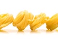 Row dry nest pasta on white