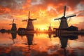 row of dutch windmills at sunset with reflections Royalty Free Stock Photo