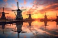 row of dutch windmills at sunset with reflections Royalty Free Stock Photo