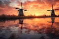 row of dutch windmills at sunset with reflections
