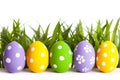 Row of Easter eggs on grass