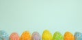 Row Easter eggs with spring light blue background Royalty Free Stock Photo