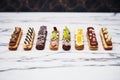 row of eclairs with different chocolate patterns