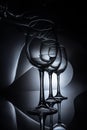 row on elegant wine glasses, dark Royalty Free Stock Photo