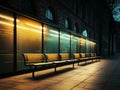 a row of empty benches on a sidewalk at night