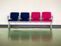 Row empty blue and pink chair in airport for waiting departure area with reflection on floor Royalty Free Stock Photo