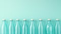 A row of empty blue-tinted glass bottles lined up on a light blue background