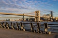 Empty Chairs along the East River with a View of the Brooklyn Bridge at the South Street Seaport in New York City