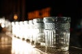 Row of empty clean glasses on counter in bar Royalty Free Stock Photo