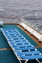 Row of empty deck chairs on the upper deck of a modern cruise. Royalty Free Stock Photo