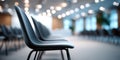 Row of empty modern chairs in a bright conference room with blurred background and ceiling lights Royalty Free Stock Photo