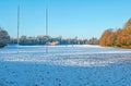 A row of empty Rugby pitches are covered in December snow