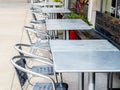 A row of empty metal tables and chairs outside Royalty Free Stock Photo