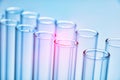 Row of empty test tubes blue background Royalty Free Stock Photo