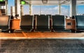 Row of empty waiting seats in the departure lounge of airport. Travel and business concept. Royalty Free Stock Photo