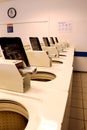 Washing machines and coin slots in a laundromat