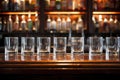 a row of empty water glasses on a bar counter Royalty Free Stock Photo