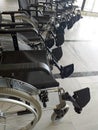 Row of empty wheelchairs in airport hall. Wheelchair service for disabled passengers or passengers with reduced mobility in the