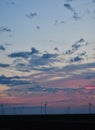 Windmills against a rainbow evening sky Royalty Free Stock Photo