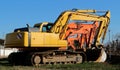 Row of  excavators lined up in a field Royalty Free Stock Photo