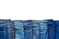 Row of fashion different jeans isolated on white