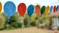 A row of felt balloons hanging on a string in the garden Royalty Free Stock Photo