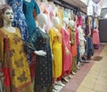 Row of female mannequins wearing traditional clothing placed in a shopping complex in India