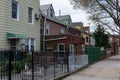 Row of Fenced In Old Brick and Wood Homes in Astoria Queens New York