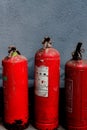 A row of fire extinguishers against the wall