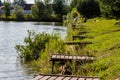 A row of fishing piers on the shore of a fishing pond