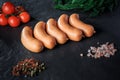 row of five raw short thick sausages with dill and tomatoes Royalty Free Stock Photo