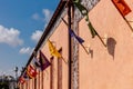 A row of flags hanging from a building Royalty Free Stock Photo